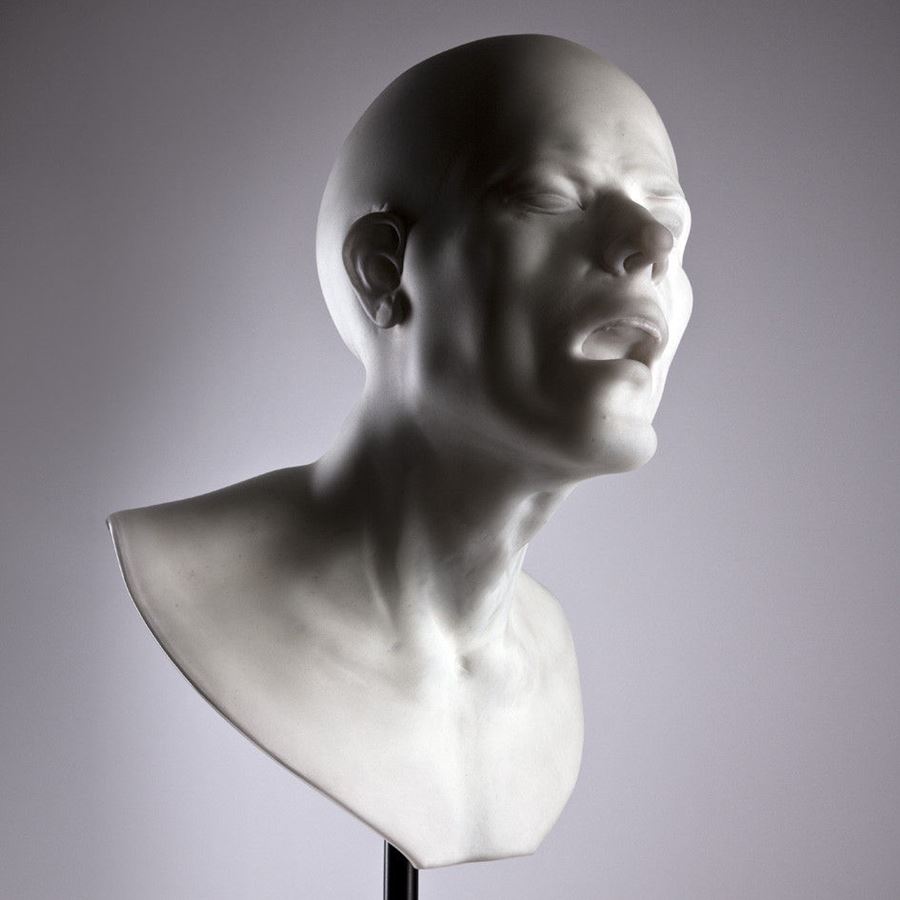 bust of head with agonised face made from glass