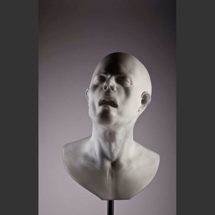 bust of head with agonised face made from glass