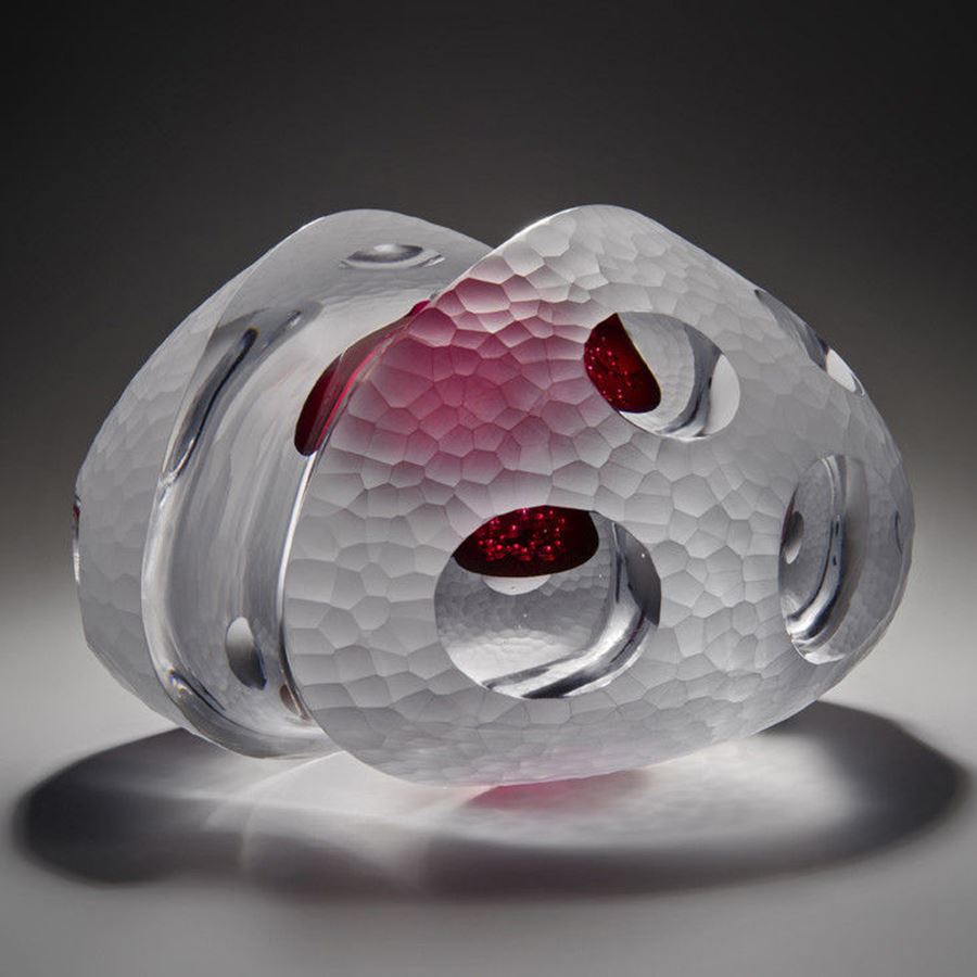 sculpted white glass artwork with pink tint