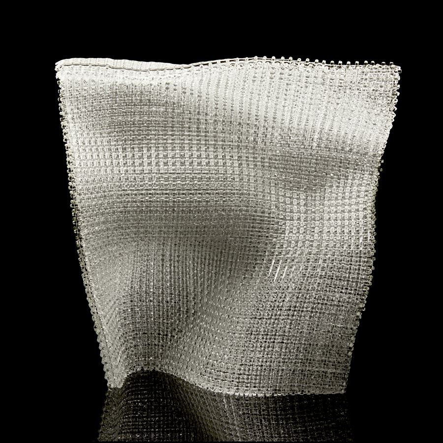 clear standing undulating soft square glass form with the appearance of woven fabric created from layers of glass canes