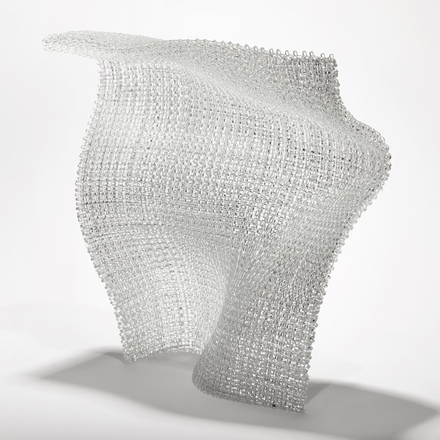 clear standing undulating soft square glass form with the appearance of woven fabric created from layers of glass canes