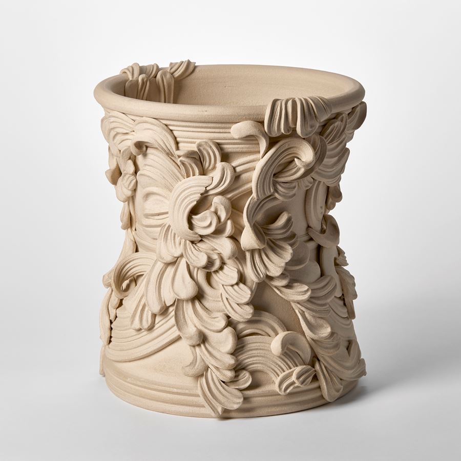 wide ceramic sculptural vessel with the appearance of weathered sandstone covered in organic swirls and flourishes hand made from white st thomas clay