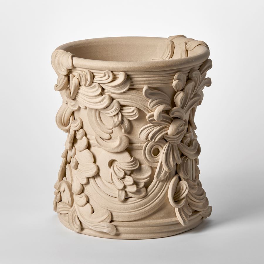 wide ceramic sculptural vessel with the appearance of weathered sandstone covered in organic swirls and flourishes hand made from white st thomas clay