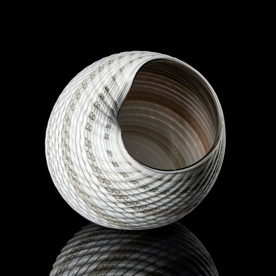 round textured shell like vessel with light matt exterior with bands of colour in white alabaster grey and bronze with darker shiny interior hand made glass