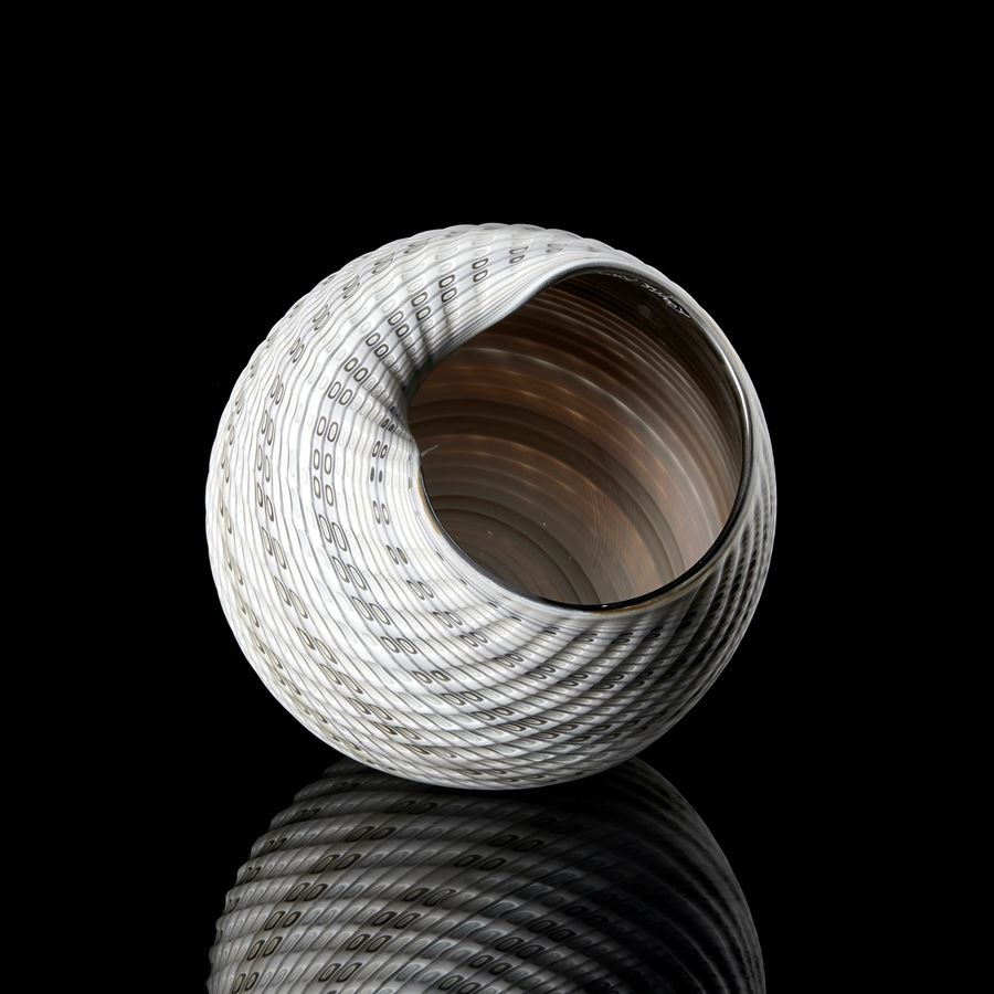 round shell like vessel with large opening glossy interior and matt exterior with incised patterned cut surface and bands of colour in bronze light grey alabaster and white 