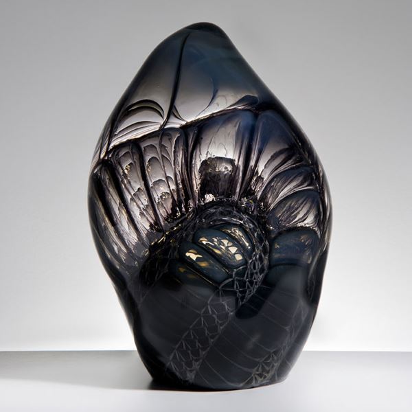 handblown and sculpted leaf-shaped glass art ornament in carbon with external embossed and engraved pattern