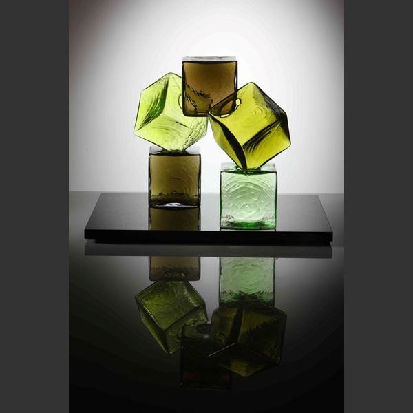 artwork of cubed glass pieces in green and brown colours on black rectangular base