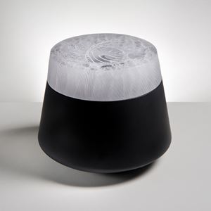 urn shaped modern cast glass sculpture with black base and white patterned top