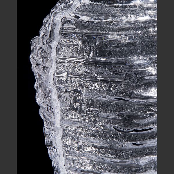 clear glass sculpted decorative tall vessel artwork with ribbed exterior pattern