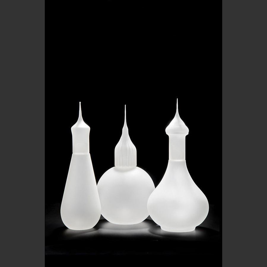 three white art glass sculptures of minarets