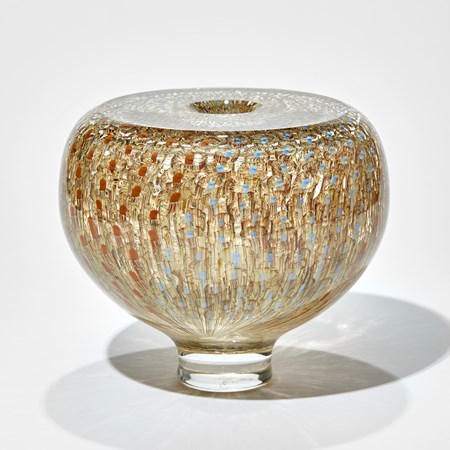 low round chunky transparent vase with tapering elegant foot and flat top surface with repeat surface pattern in gold brown celadon and turquoise hand made from glass
