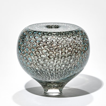 rounded chunky transparent vase with tapered foot and flat top surface with trapped murrine repeat pattern in grey celadon and turquoise handmade from glass 
