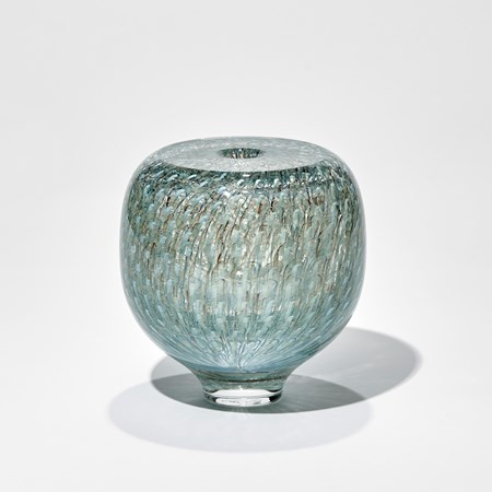 small round transparent vase with flat top and small top opening with incased repeat murrine pattern in teal celadon and pale turquoise hand made from glass