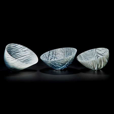 three art glass bowl sculptures in white with black stripes