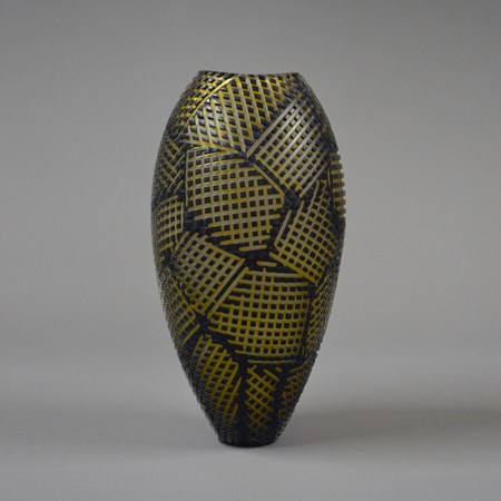 tall glass vase sculpture in black with gold checked patterns