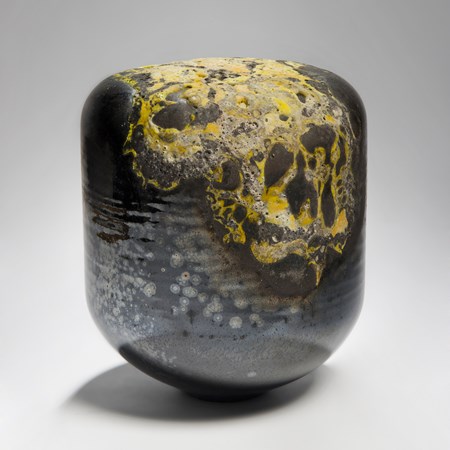 abstract contemporary glass sculpture in dark colours and yellow