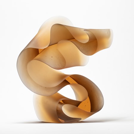 abstract contemporary glass art sculpture of swirling line in amber
