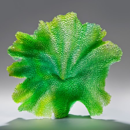 glass art sculpture of leaf in bright green