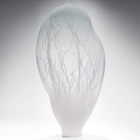 grey floating orb shaped art glass sculpture with internal tree branch structure