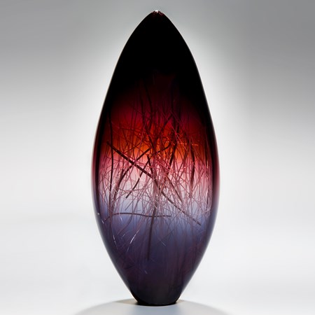 tall sculpted glass vase in deep violet red and black with internal wire structure