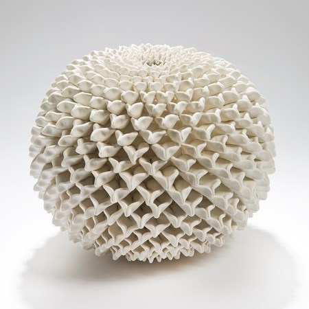 a round ceramic sculptured vessel with 3d patterned chrysanthemum in white
