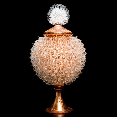 pink bronze glass sculpture of round jar atop cone shaped base with white thistle top 