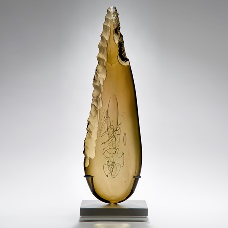 bronze leaf shaped art glass sculpture on grey base