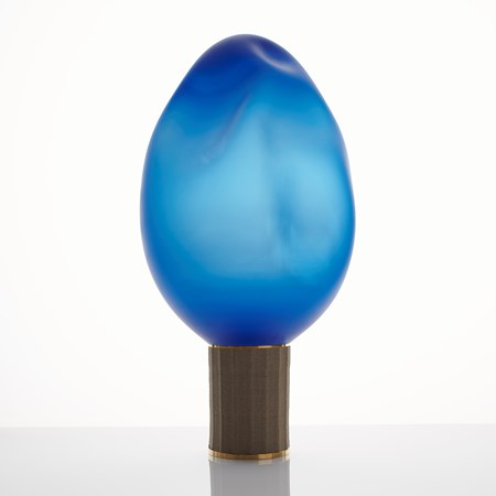 contemporary art glass sculpture resembling lightbulb of blue oval shaped top resting on bronze base