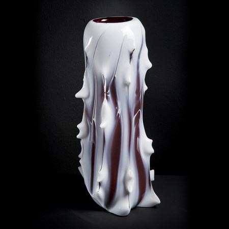 abstract tall glass sculpturein white with protruding edges and slightly melted look