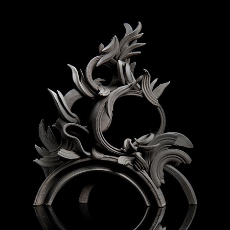 black stoneware sculpture in classical style with arcs and flares