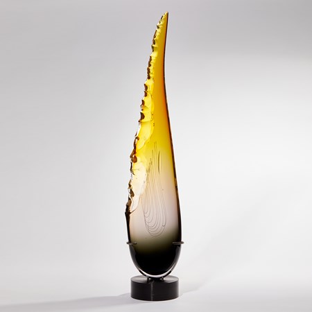 tall pointed teardrop shaped sculpture in grey and yellow with chipped edge handmade from glass