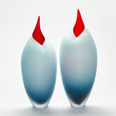 Stylised sleek tall bird shaped handmade paid of sculptures in blue and red