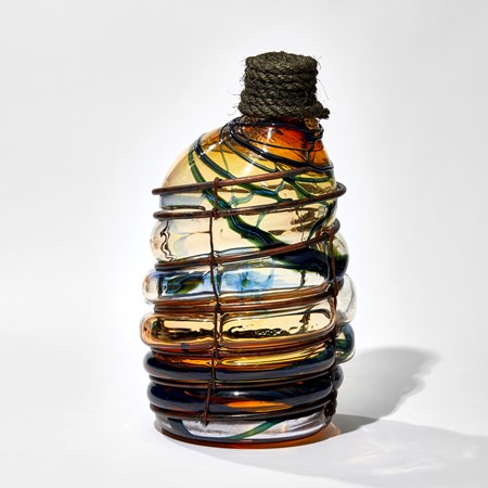 amber blue and red wonky hand made large glass bottle blown in a copper cage with rope bung