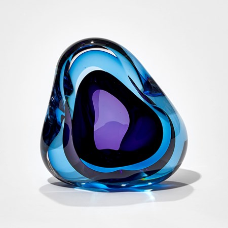 deep turquoise and purple amorphic sculpture hand crafted from glass with central opening