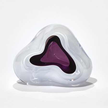 white and purple amorphic yet slightly triangular sculpture handmade from glass with purple middle