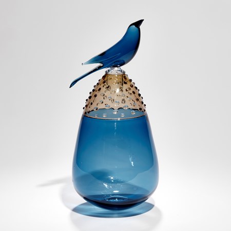 teardrop shaped blue and fawn coloured handmade glass vessel with blue glass sculpted on top