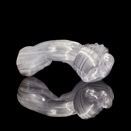chunky bowed white glass sculpture with the appearance as if made from pulled sugar cane with a knot at one end