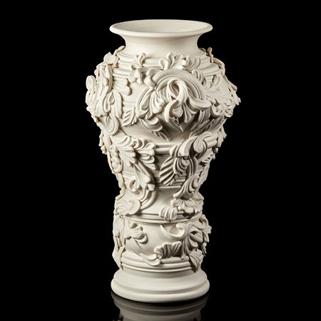 undulating column vase handmade from porcelain covered in organic flourishes and abstract leaves with rounded opening at the top