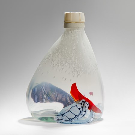 soft pyramid bottle in clear and mottled white with patches of grey and red hand made from glass with ocean plastic cap on top