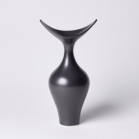 classically shaped based vase with wide curved sweeping rim ending in two raised points hand made from porcelain