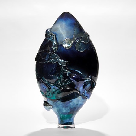 dark intense metallic blue teardrop shaped vase with organic trailing and swirling raised texture hand made from glass