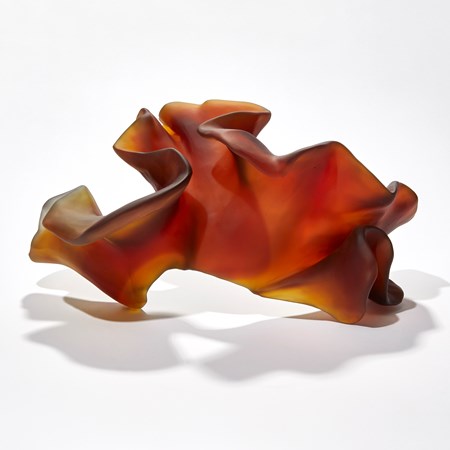 rich dark amber abstract organic sculpture with the appearance of a piece of simplified coral or seaweed hand made from glass