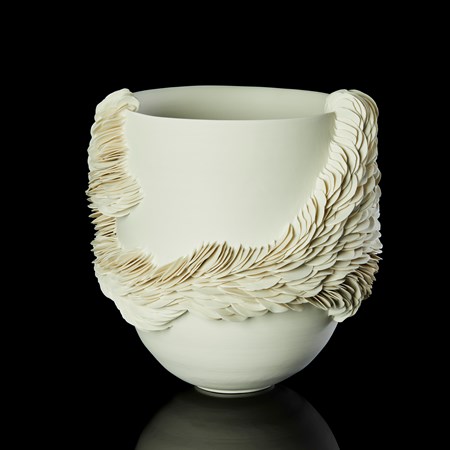 round high sided off white alabaster coloured bowl with exterior organic repeated decorative texture made up of hundreds of scale like shards encircling the main form and reaching the rim in two places hand made from thrown and sculpted porcelain 