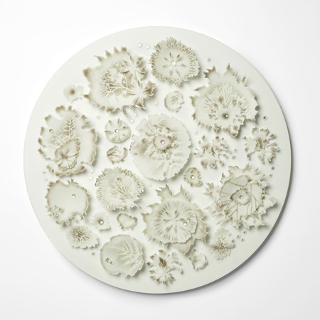 opaque white round wall hung artwork with front face covered in organic growths and mushroom gill inspired details with soft bronze brown speckled colour drops of clear glass water like droplets and silver highlights handmade from glass 