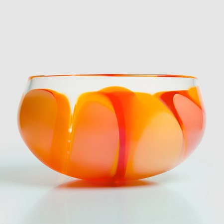 round low clear hand blown glass bowl centrepiece with thick soft bands and sections of colour in yellow gold peach and red
