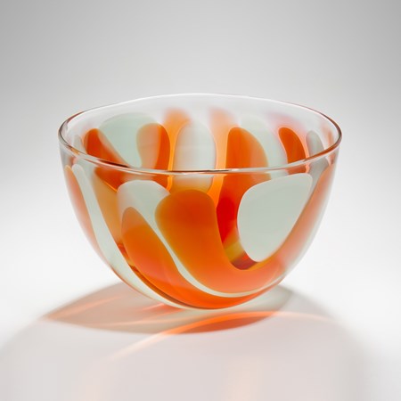 small bowl glass sculpture with orange and white swirls resembling colours of an egg