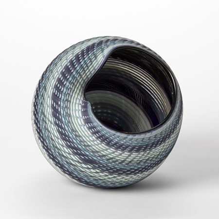 round vessel with wide opening and meandering wide rim with bands of colours in jade indigo blue white and cream hand made from glass with a matt exterior and glossy interior