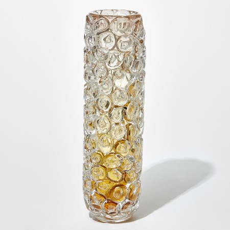 cylindrical transparent tall vase with dark amber base fading to clear at the top with the outer surface covered in enlarged bubbles just like bubblewrap hand made from glass