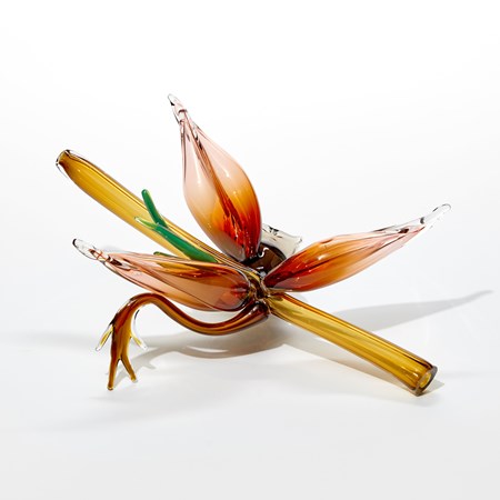 transparent golden amber straight tubular stem with three pointed blossoms in rich orange peach with two tendrils in dark amber and verdant green handmade from glass 