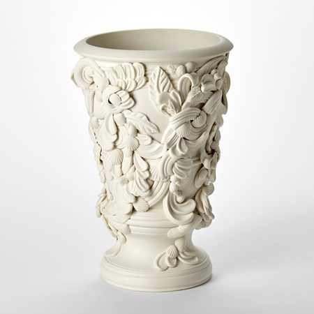 flared tubular vase with architectural details of swirls leaves and shells over the surface with ridged foot ring hand made from porcelain